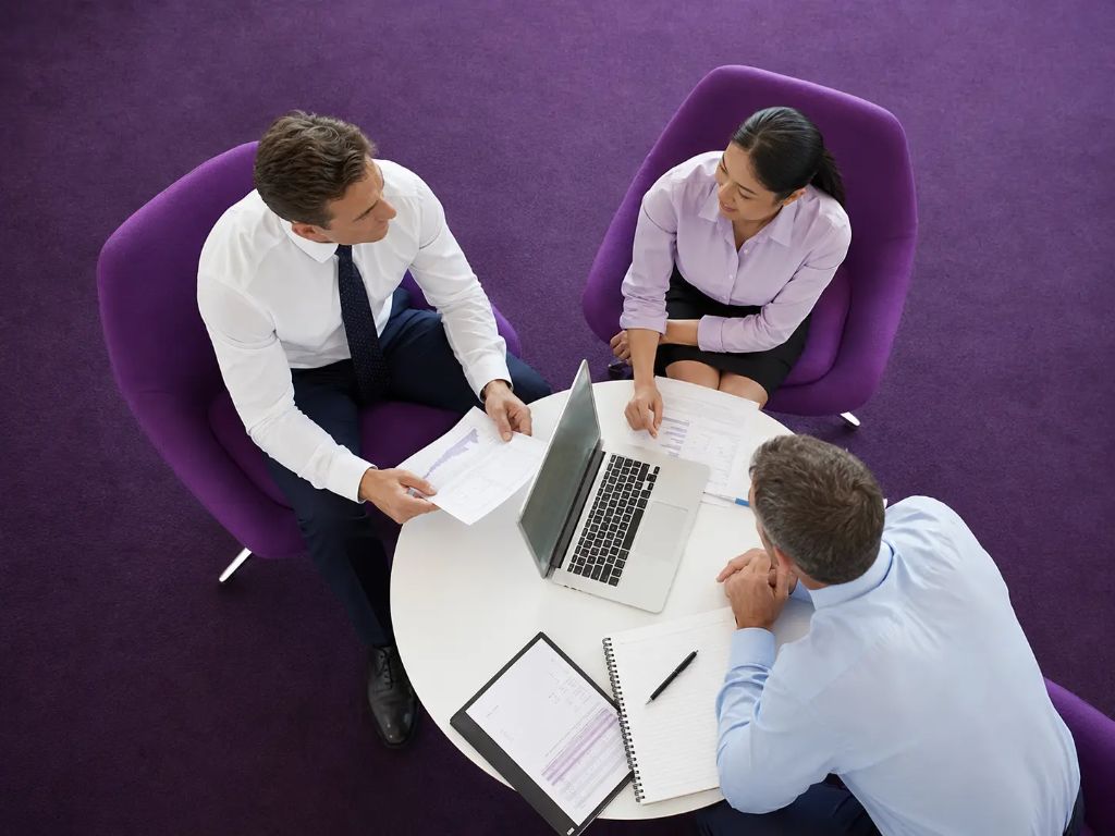 Business advisors meeting with a client to discuss funding options